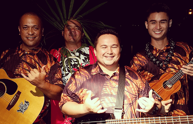 hawaiian musician band doing shaka hand sign