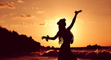 beautiful hula dancer in the sunset on the beach