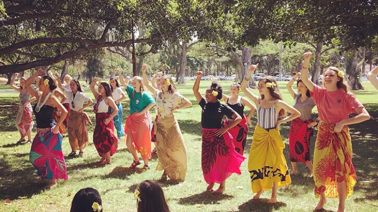 group of friends learning the hula in hawaii